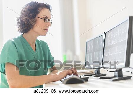 Stock Photograph - Female technician working on computer. Fotosearch