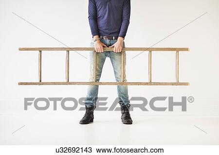 Low section of man carrying ladder View Large Photo Image Stock Image - Low section of man carrying ladder. Fotosearch