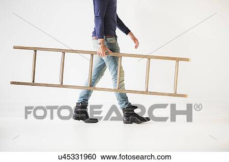 Low section of man carrying ladder View Large Photo Image Stock Image - Low section of man carrying ladder. Fotosearch