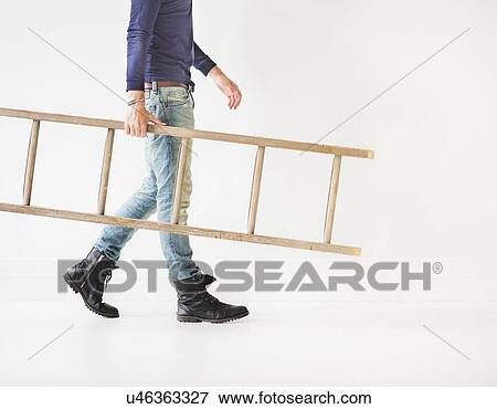 Low section of man carrying ladder View Large Photo Image Stock Photo - Low section of man carrying ladder. Fotosearch