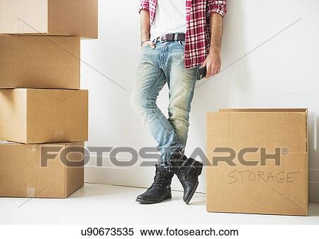 Low section of man next to stack of cardboard boxes View Large Photo Image Stock Photography - Low section of man next to stack of cardboard boxes. Fotosearch