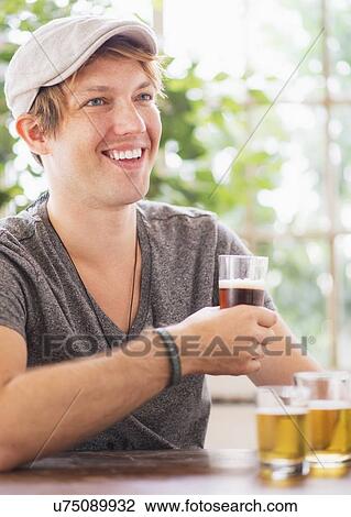 Man holding glass of beer View Large Photo Image Stock Image - Man holding glass of beer. Fotosearch