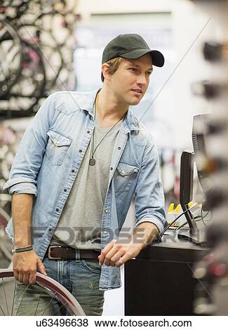 Man in bike shop View Large Photo Image Stock Photo - Man in bike shop. Fotosearch