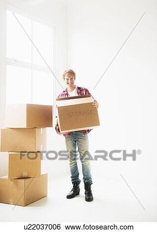 Man with stack of cardboard boxes View Large Photo Image Stock Photograph - Man with stack of cardboard boxes. Fotosearch