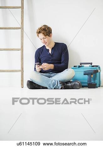 Man with toolbox using phone View Large Photo Image Stock Photo - Man with toolbox using phone. Fotosearch
