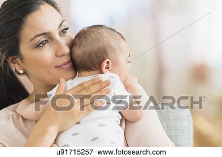 Stock Photo - Mother embracing baby boy (2-5 months) . Fotosearch