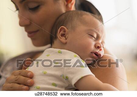 Stock Image - Mother holding baby (2-5 months). Fotosearch