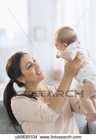 Mother holding baby boy (2-5 months) View Large Photo Image Picture - Mother holding baby boy (2-5 months) . Fotosearch