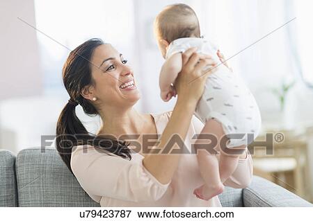 Mother holding baby boy (2-5 months) View Large Photo Image Stock Photo - Mother holding baby boy (2-5 months) . Fotosearch