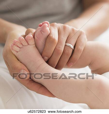 Mother holding baby boy's (2-5 months) feet View Large Photo Image Stock Image - Mother holding baby boy's (2-5 months) feet. Fotosearch