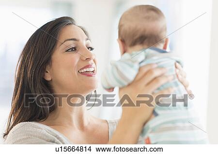 Picture - Mother playing with baby (2-5 months). Fotosearch