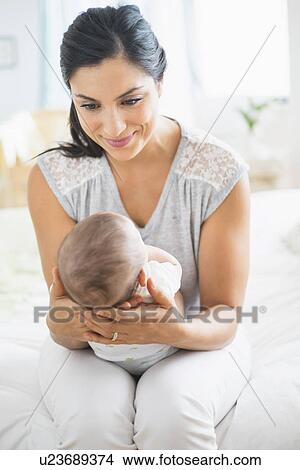 Picture - Mother playing with baby (2-5 months). Fotosearch