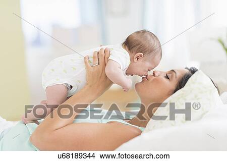 Mother playing with baby (2-5 months) View Large Photo Image Picture - Mother playing with baby (2-5 months). Fotosearch