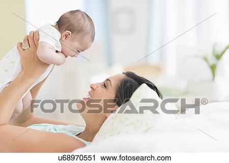 Mother playing with baby (2-5 months) View Large Photo Image Stock Image - Mother playing with baby (2-5 months). Fotosearch