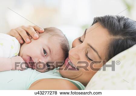 Stock Photo - Mother playing with baby (2-5 months). Fotosearch