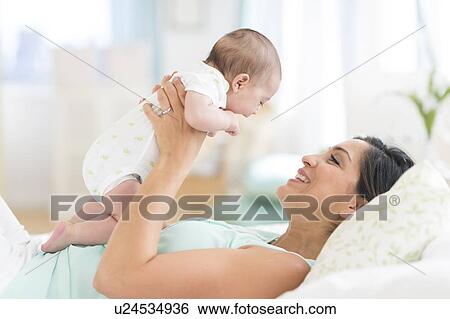 Mother playing with baby (2-5 months) View Large Photo Image Stock Photograph - Mother playing with baby (2-5 months). Fotosearch