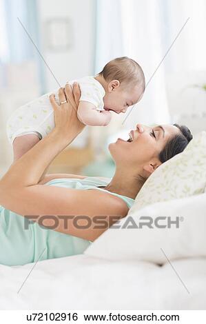 Mother playing with baby (2-5 months) View Large Photo Image Stock Photograph - Mother playing with baby (2-5 months). Fotosearch