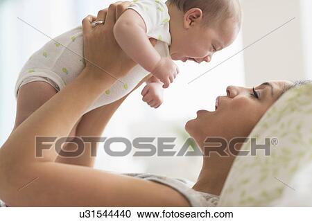 Mother playing with baby boy (2-5 months) View Large Photo Image Stock Image - Mother playing with baby boy (2-5 months). Fotosearch