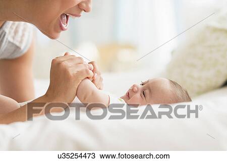 Mother playing with baby boy (2-5 months) View Large Photo Image Stock Image - Mother playing with baby boy (2-5 months). Fotosearch