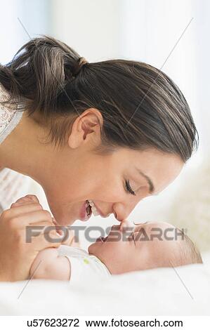 Mother playing with baby boy (2-5 months) View Large Photo Image Stock Image - Mother playing with baby boy (2-5 months). Fotosearch