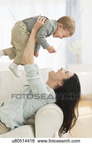 Mother playing with son (12-17 months) View Large Photo Image Stock Photograph - Mother playing with son (12-17 months). Fotosearch