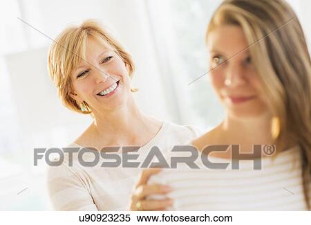 Mother with adult daughter, focus on background View Large Photo Image Stock Photography - Mother with adult daughter, focus on background. Fotosearch
