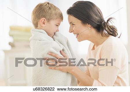Mother with son (6-7) wrapped in towel View Large Photo Image Stock Image - Mother with son (6-7) wrapped in towel. Fotosearch
