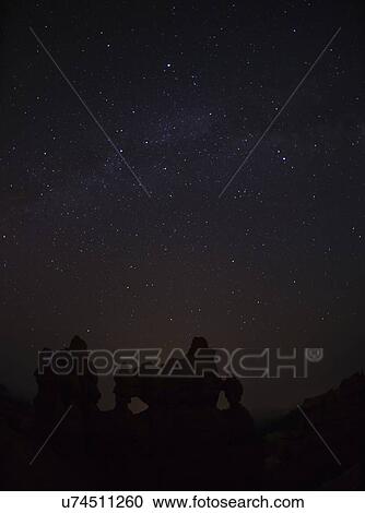 Stock Image - Night sky above rocks. Fotosearch