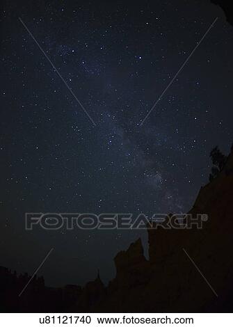 Stock Image - Night sky above rocks. Fotosearch
