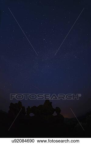 Stock Image - Night sky above rocks. Fotosearch