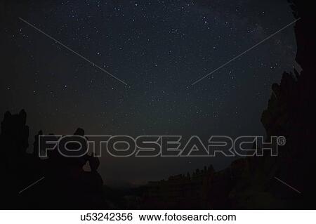 Stock Photograph - Night sky above rocks. Fotosearch