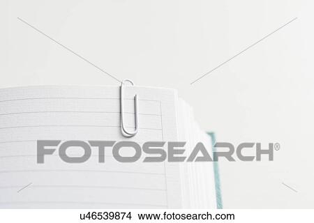 Picture - Open and empty journal with paper clip attached. Fotosearch