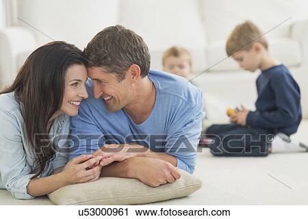 Stock Image - Parents with kids (12-17 months, 6-7) at home. Fotosearch