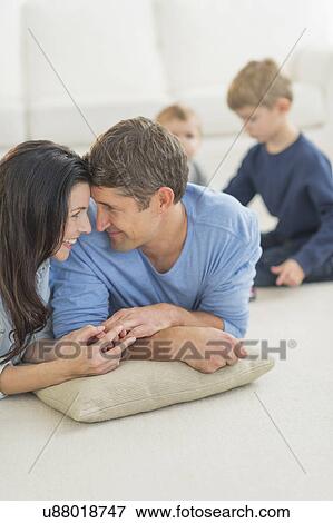 Stock Photo - Parents with kids (12-17 months, 6-7) at home. Fotosearch
