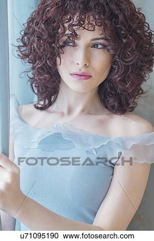 Stock Image - Portrait of beautiful brunette woman. Fotosearch