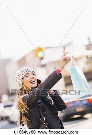 Portrait of blond woman hailing cab View Large Photo Image Stock Image - Portrait of blond woman hailing cab. Fotosearch