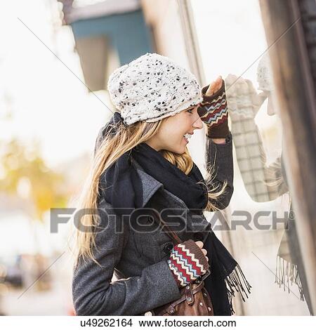 Portrait of blond woman looking at window display View Large Photo Image Picture - Portrait of blond woman looking at window display. Fotosearch