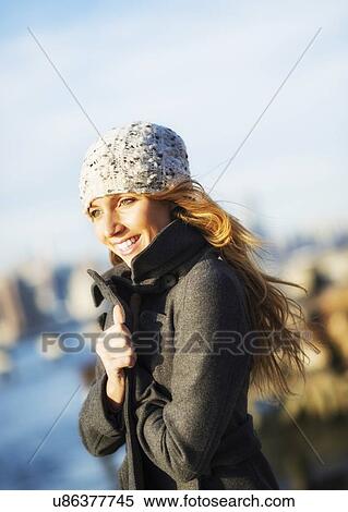 Portrait of cheerful woman in overcoat in autumn View Large Photo Image Stock Photography - Portrait of cheerful woman in overcoat in autumn. Fotosearch