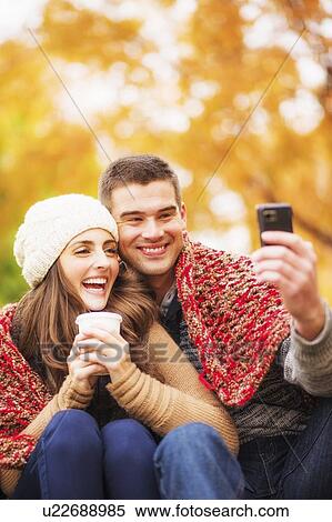 Portrait of couple in Central Park taking photo of themselves View Large Photo Image Stock Photography - Portrait of couple in Central Park taking photo of themselves. Fotosearch