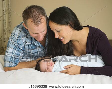Portrait of family with newborn baby boy (0-11 months) View Large Photo Image Stock Photo - Portrait of family with newborn baby boy (0-11 months). Fotosearch
