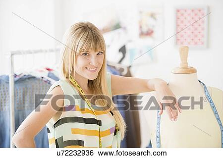 Stock Photograph - Portrait of female fashion designer in studio. Fotosearch