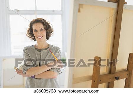 Portrait of female painter in studio View Large Photo Image Stock Photo - Portrait of female painter in studio. Fotosearch