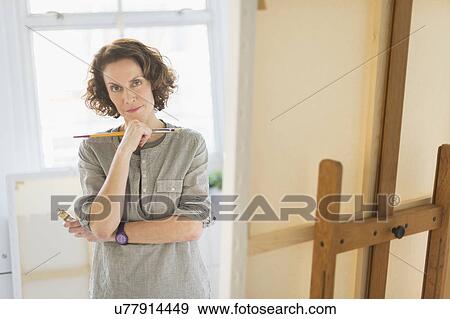 Portrait of female painter in studio View Large Photo Image Stock Photo - Portrait of female painter in studio. Fotosearch