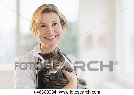 Picture - Portrait of female vet with cat. Fotosearch