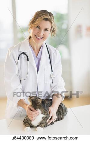 Stock Photo - Portrait of female vet with cat. Fotosearch