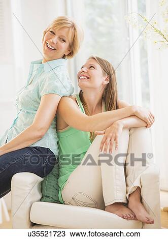 Stock Image - Portrait of mother and adult daughter. Fotosearch