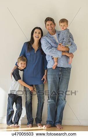 Stock Image - Portrait of parents with two sons (12-17 months, 6-7). Fotosearch