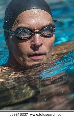 Portrait of swimmer wearing cap and goggles View Large Photo Image Stock Photo - Portrait of swimmer wearing cap and goggles. Fotosearch