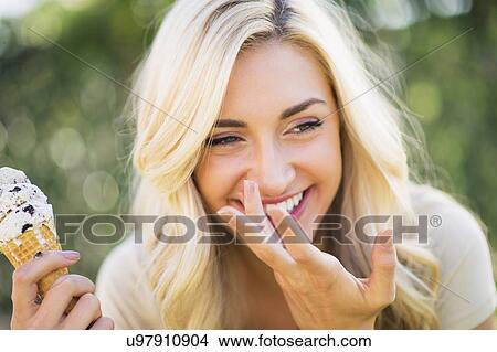 Picture - Portrait of teenage girl (16-17) eating ice cream. Fotosearch