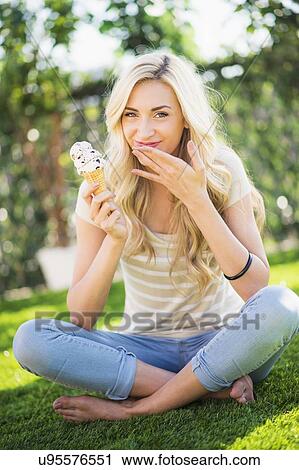 Stock Image - Portrait of teenage girl (16-17) eating ice cream. Fotosearch
